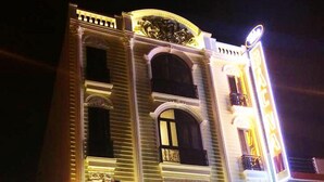 A building with a classical architectural style, featuring a central entrance with a large archway, multiple windows, and a balcony on the upper floor. - Bac Nam Motel (Da Nang)