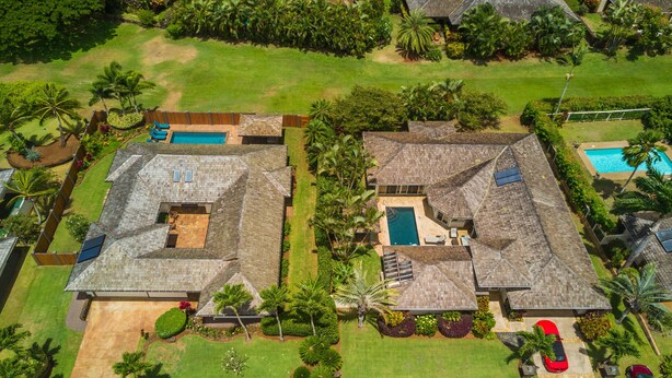 An aerial view of a residential area with two houses, each with a swimming pool, surrounded by lush greenery and palm trees. - 5 Star, Great for Families, 4BD w/AC, HTD Pool, Poipu Beach Athletic Club access (Koloa)