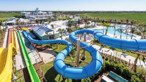 A water park with multiple water slides and a pool area.