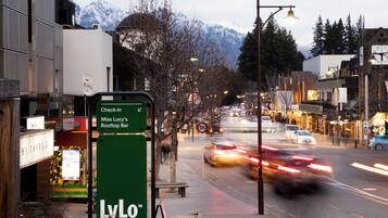 A street view with a sign for 'LyLo' and a mountain backdrop.