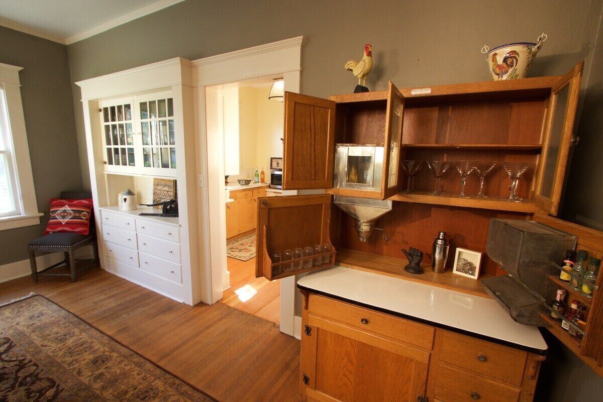 A kitchen with wooden cabinets, a white countertop, and a window.