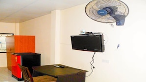 A small office with a desk, chair, and a wall-mounted TV. - Bonus Bungalow (Chalong)