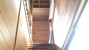 A wooden staircase with a handrail, leading to a higher floor. - Rulo Classic Garden (Kaiyo)