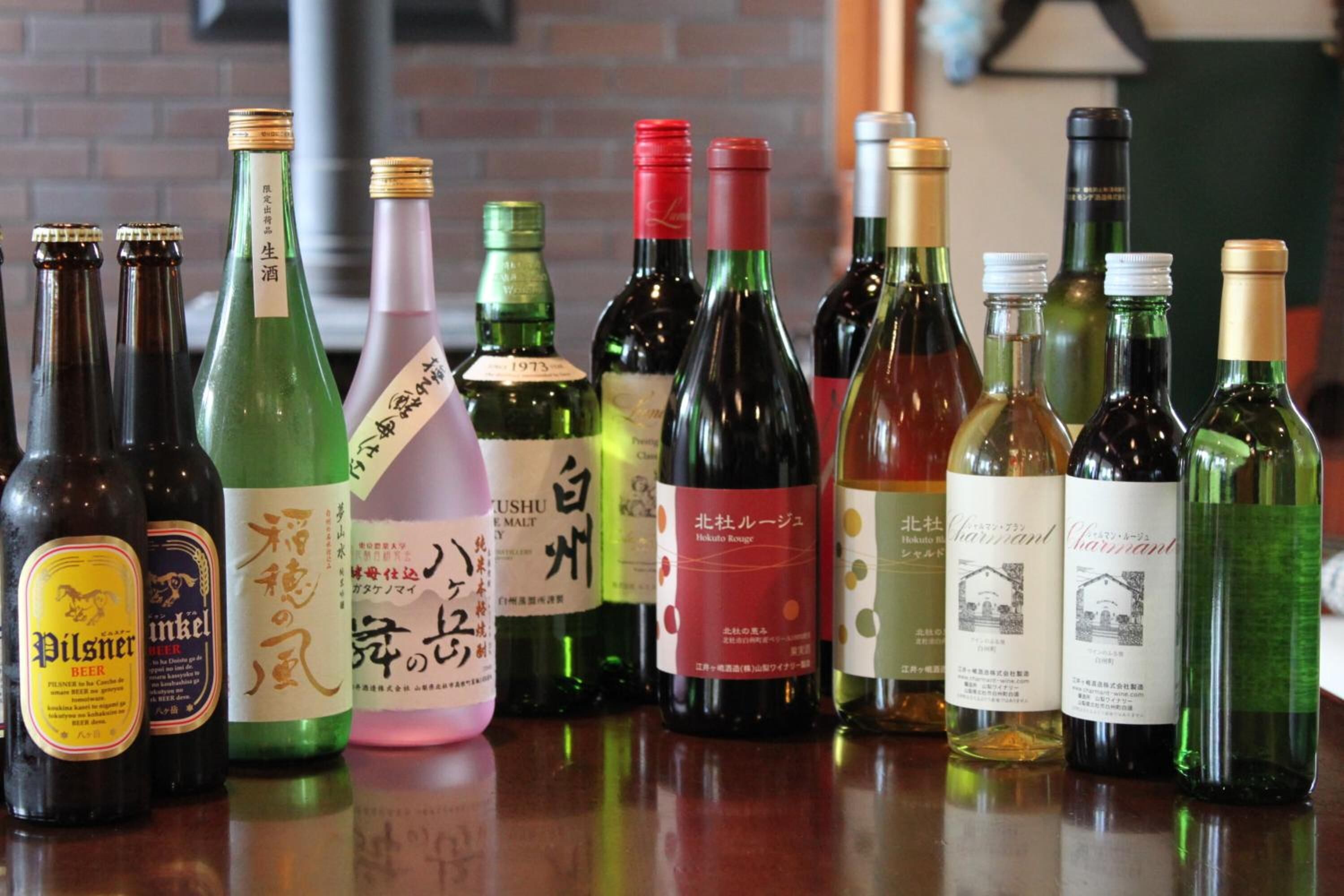A variety of bottled beverages, including beer and wine, arranged on a counter.
