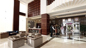 A spacious lobby with a reception desk, multiple seating areas, and a polished floor. - Swiss Flora Inn Hotel Riyadh (Riyadh)