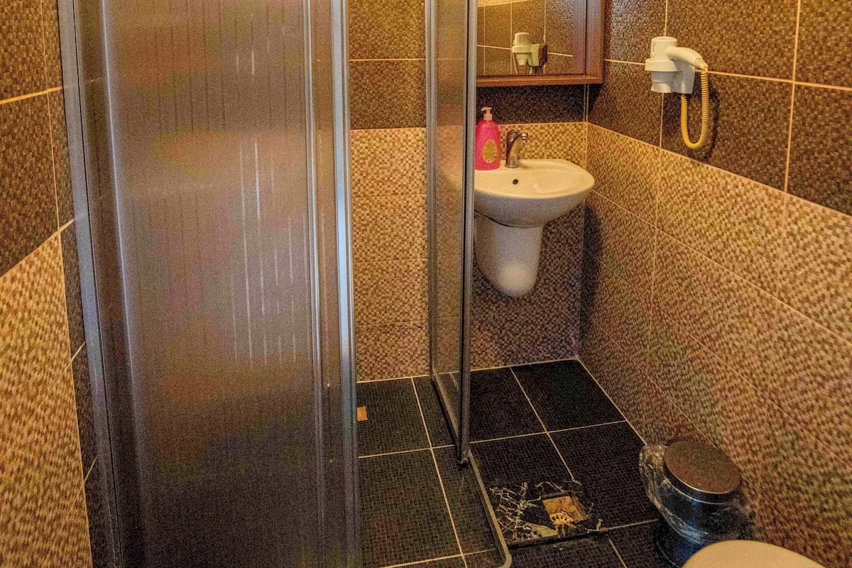 Shower, hair dryer, slippers, towels