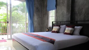 A large bed with a white and red bedspread, a dark headboard, and two pillows with gold and white patterns. - Real Relax Resort & Beauty Massage (Krabi)