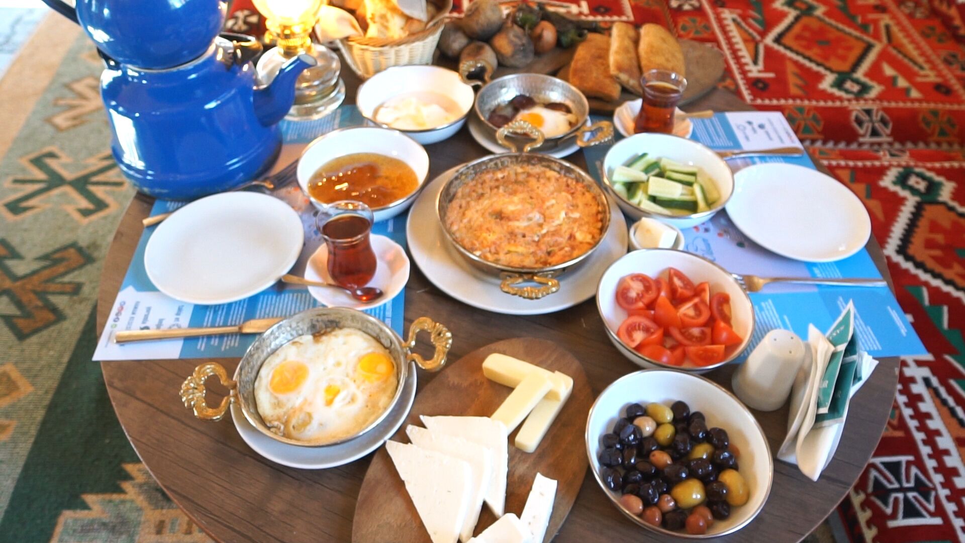 A table set with various dishes, including eggs, olives, and bread, suggesting a meal setting.