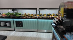 A buffet setup with various food items and a beverage dispenser. - Basaranlar Thermal Hotel (Ihsaniye)