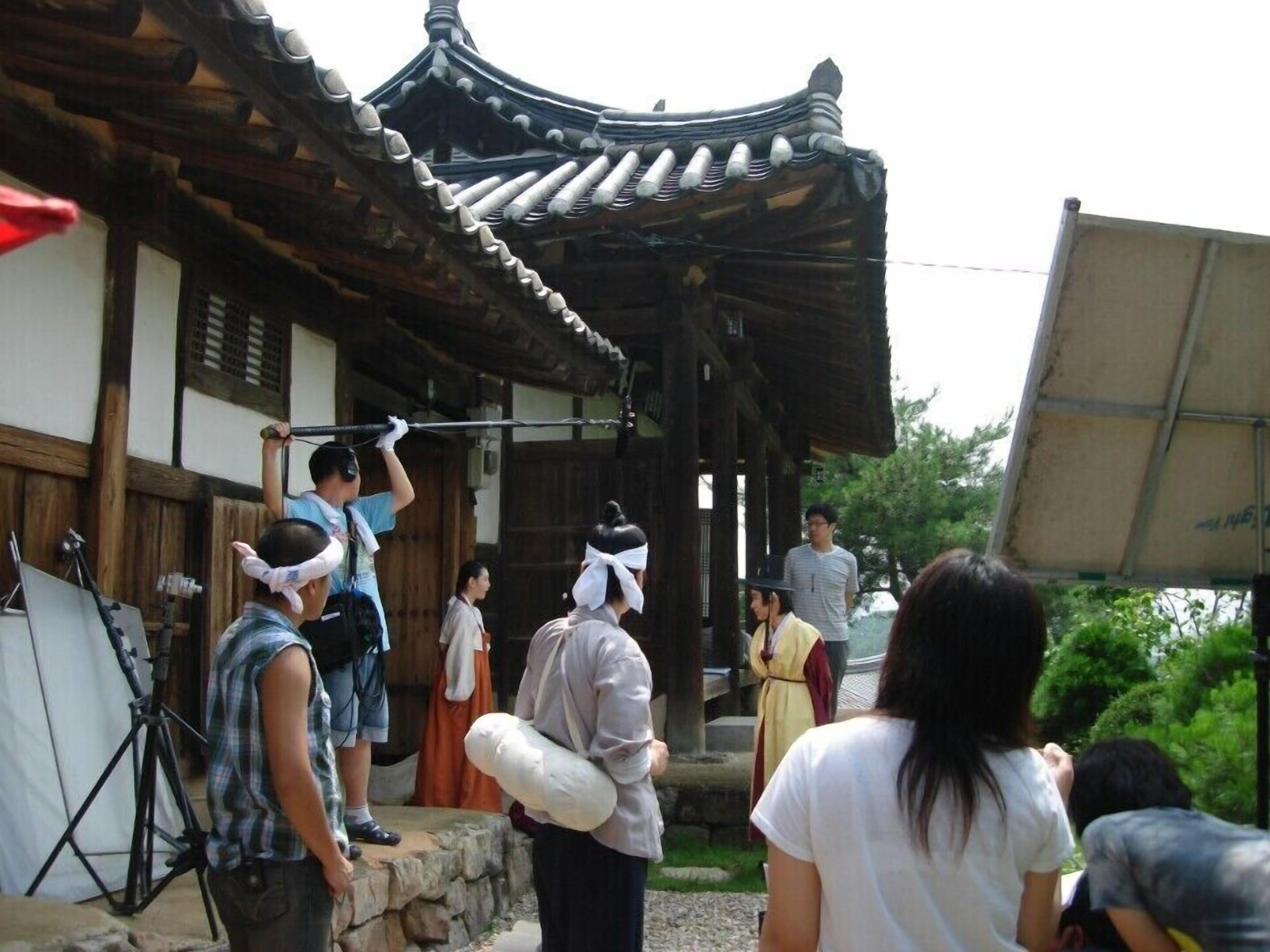 A traditional building with a curved roof and wooden beams.