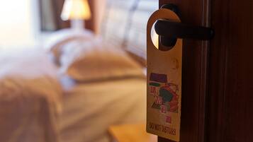 A hotel room door with a 'Do Not Disturb' sign.
