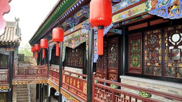 A traditional Chinese building with ornate decorations, red lanterns, and intricate woodwork.