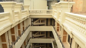 A multi-level atrium with a central garden area, balconies, and a modern architectural design. - The Axana Hotel (Padang)