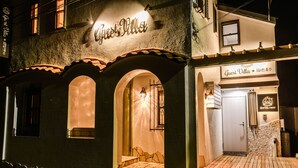 Un edificio con un letrero que dice 'Guest Villa' y fachada de piedra.