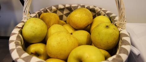 A basket filled with yellow apples.