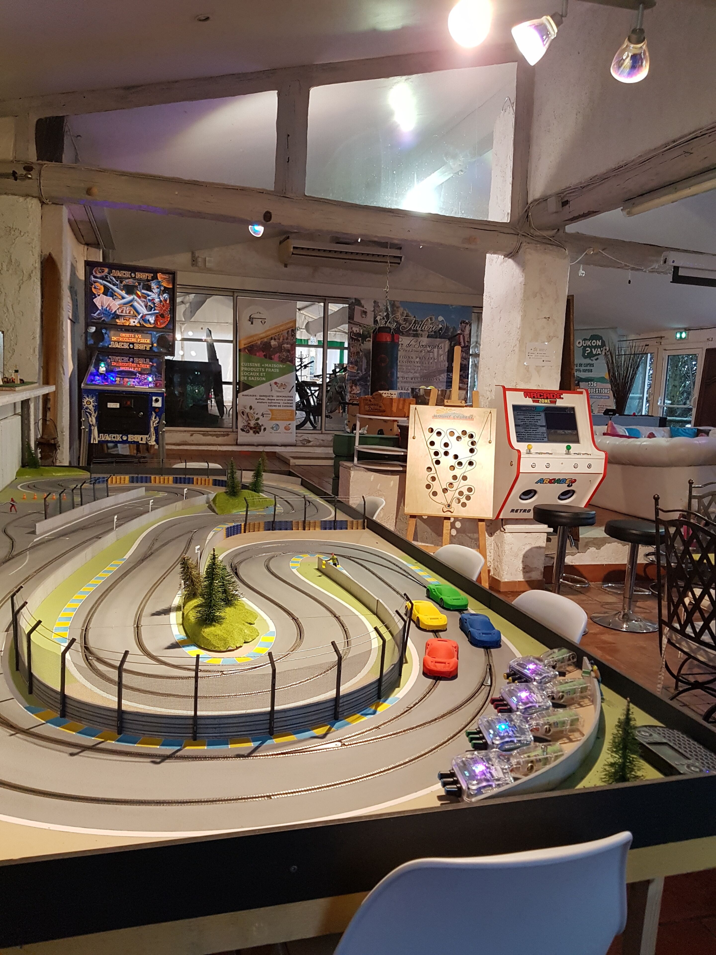 A model racing track with cars and a control panel.