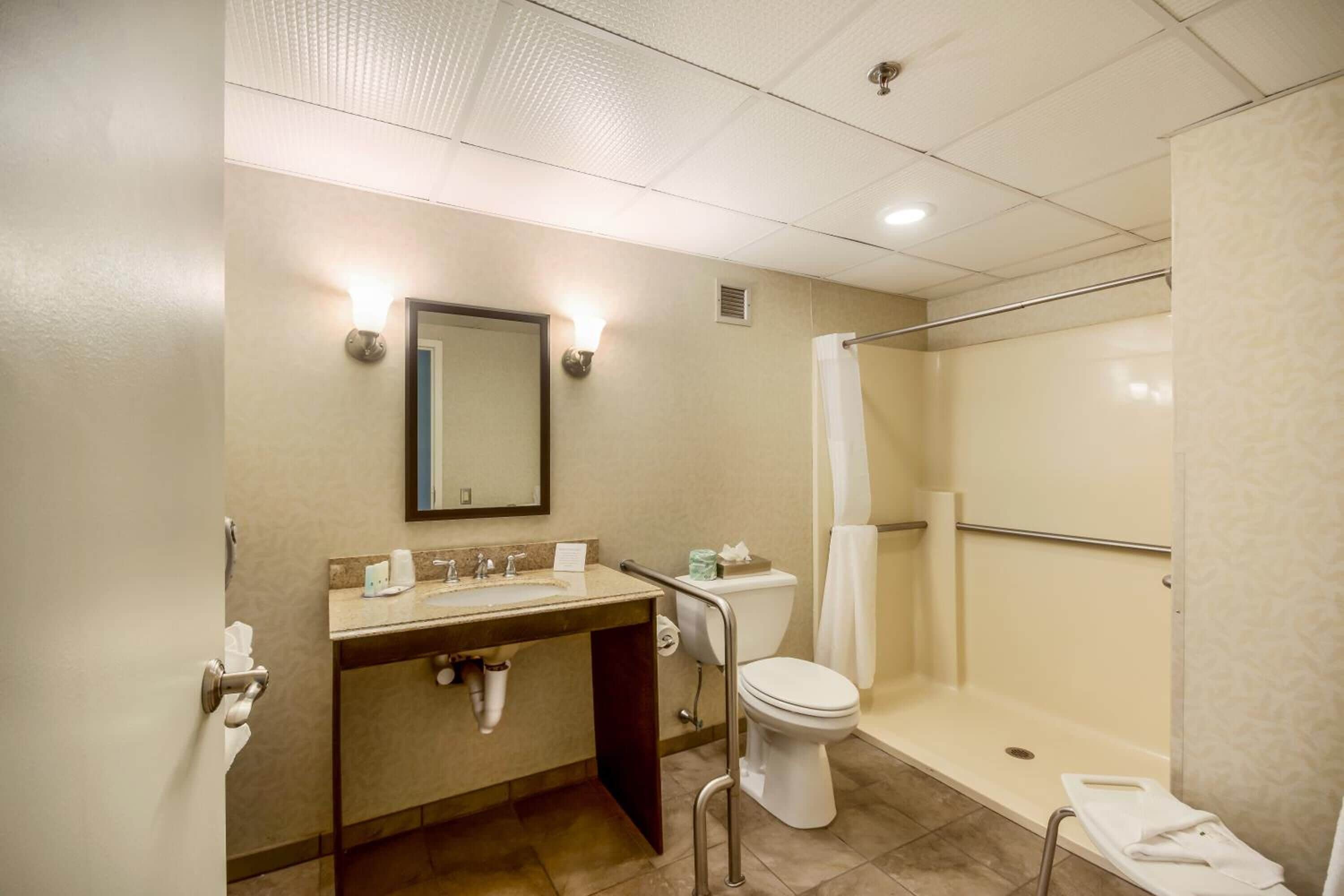 A bathroom with a sink, toilet, and shower.