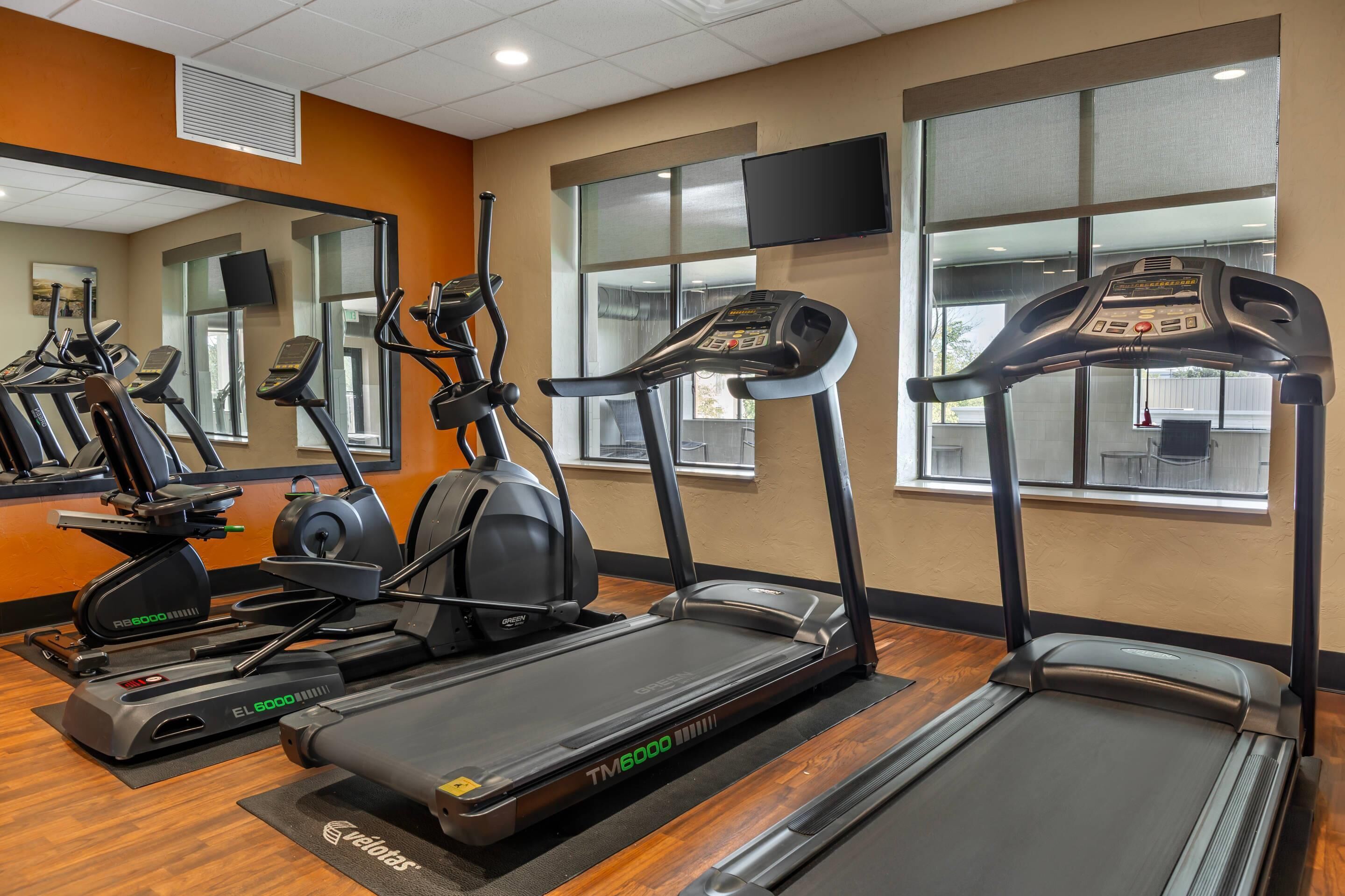 A gym with treadmills, ellipticals, and stationary bikes.