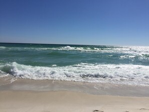 A beach with waves crashing onto the shore and a clear blue sky. - Beach House - Glory Daze by Panhandle Getaways (Panama City Beach)