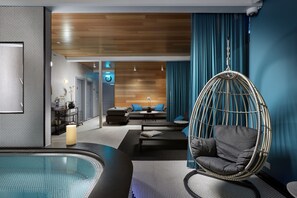 A modern spa room with a hot tub, a hanging chair, and a seating area with a sofa and coffee table. - Reykjavik Konsulat Hotel, Curio Collection by Hilton (Reykjavik)