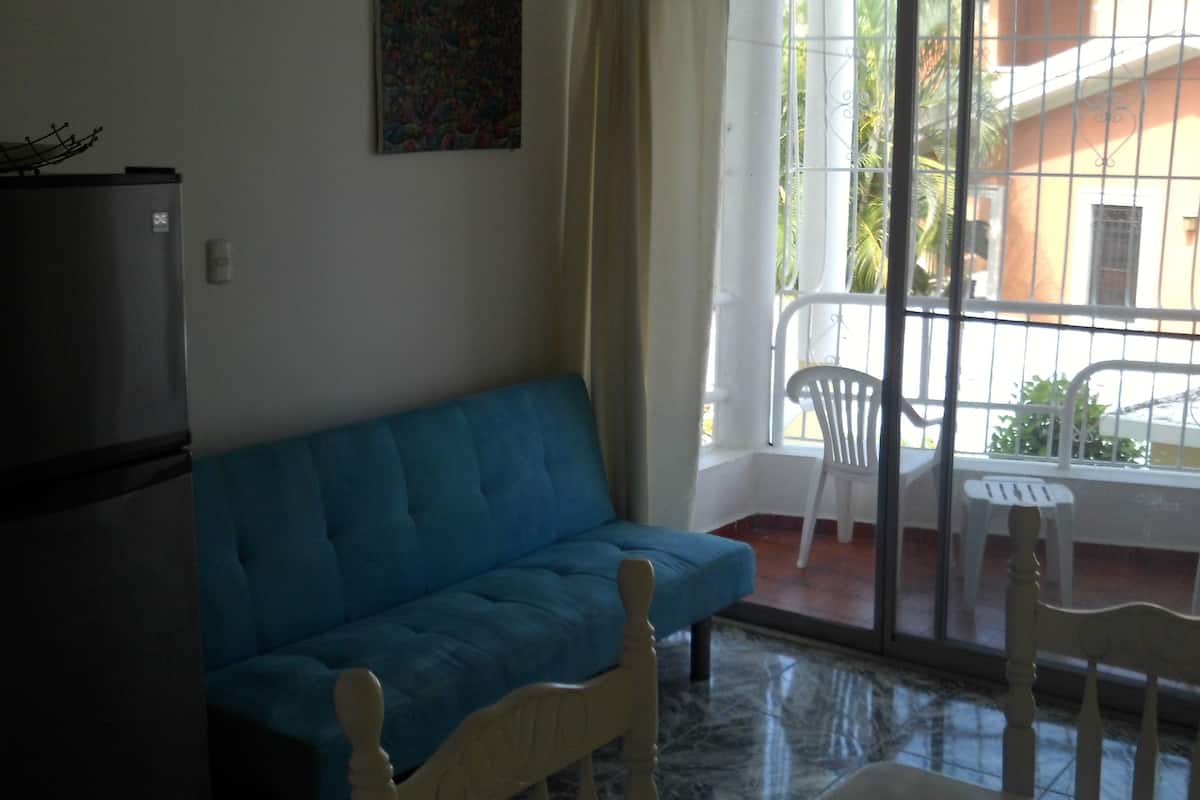 comfort apartment, 1 double bed, smoking, garden view | living room | flat-screen tv