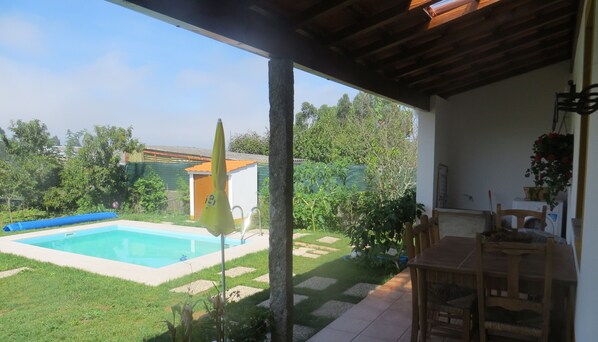 Enjoy dining or socializing on the patio with a clear view of the pool and garden.