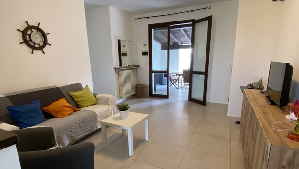A modern living room with a sofa, a coffee table, and a TV stand. - Villa Lido di Spina "Adriatic coast" (Lido di Spina)