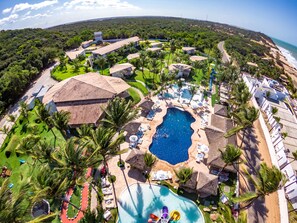 An aerial view of a resort with multiple swimming pools, palm trees, and beachside accommodations. - Acquapipa Resort (Tibau do Sul)