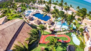 A resort with multiple swimming pools, palm trees, and a beach view. - Acquapipa Resort (Tibau do Sul)