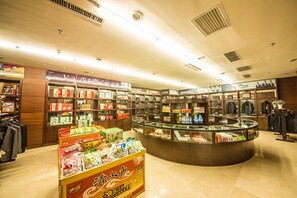 A well-lit store with various products on shelves and a central display area.