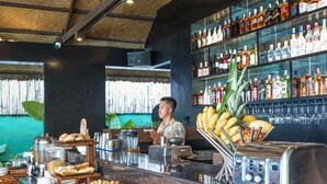 A buffet with various food items and a bar area with a variety of beverages. - Siargao Island Villas (General Luna)