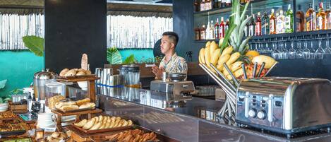 A buffet with various food items and a bar area with a variety of beverages.