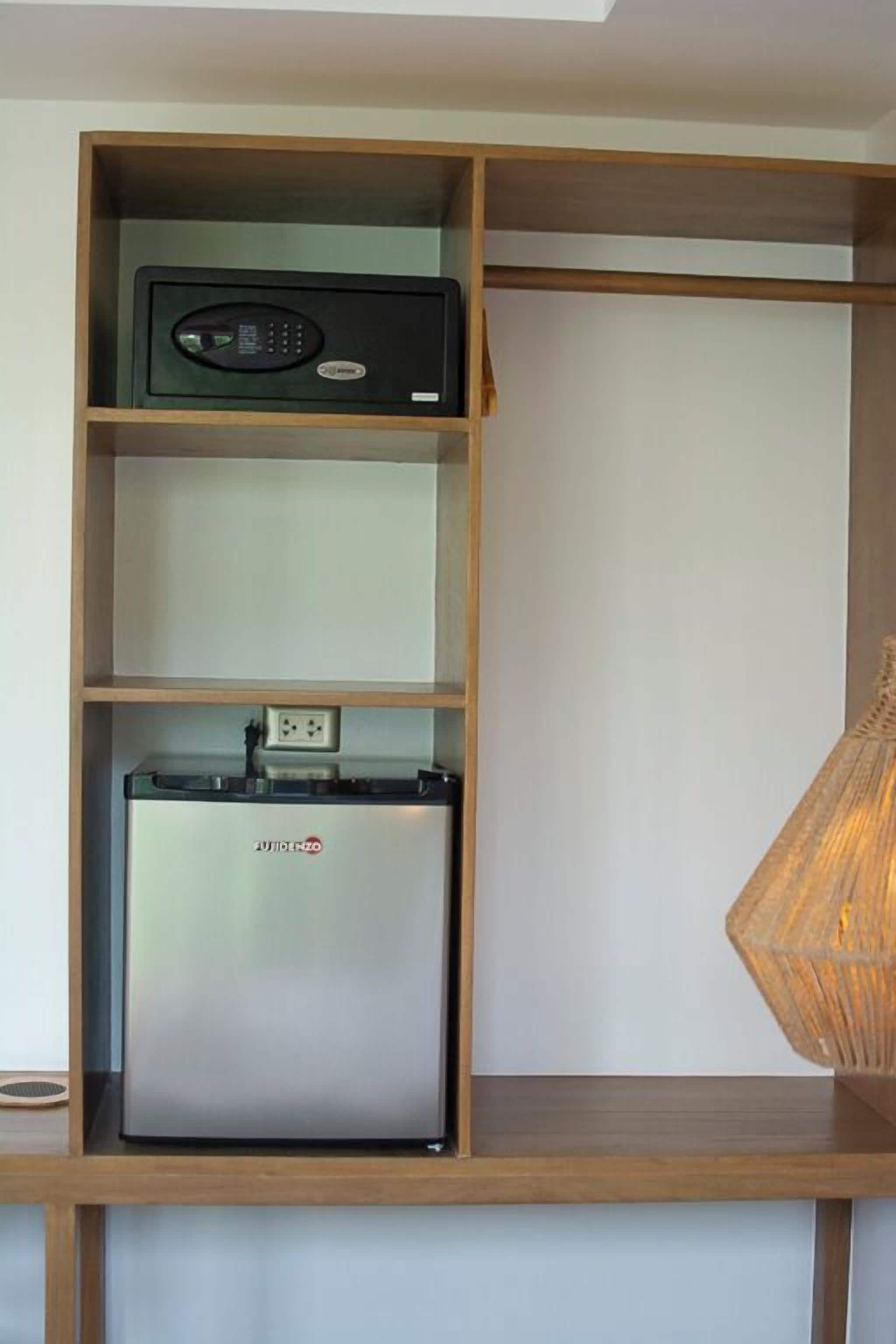 A kitchen with a built-in refrigerator, a microwave, and a shelf above.