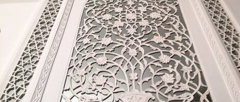 A detailed architectural design with intricate patterns and a central floral motif.