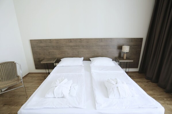 Down duvets, desk, iron/ironing board, free cots/infant beds