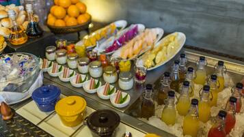 A buffet with various food items and beverages.