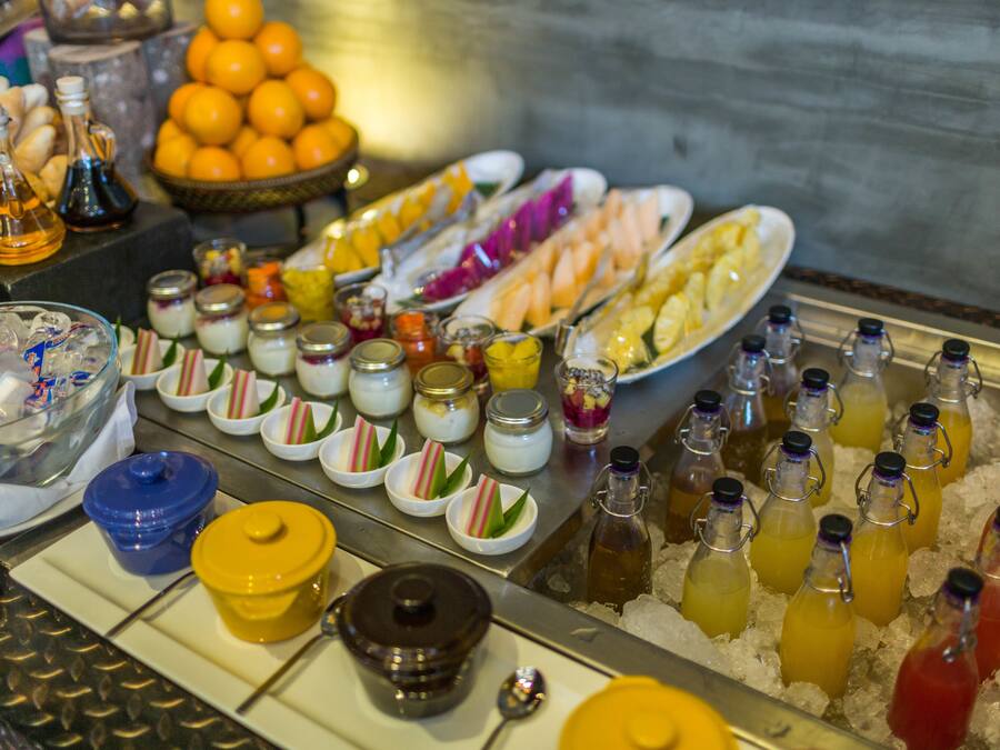 A buffet with various food items and beverages.
