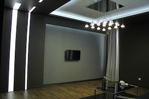 Deluxe Double Room, 2 Bedrooms | Living room | Flat-screen TV
