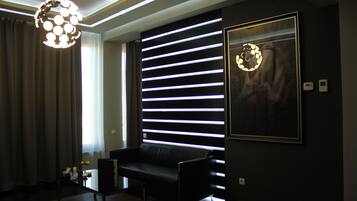 Deluxe Double Room, 1 Bedroom | Living room | Flat-screen TV