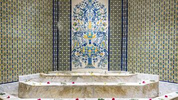 Experience the tranquil ambiance of this serene space, surrounded by a central fountain and intricate tile patterns.