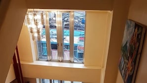 A staircase leading to a balcony with a view of the outside. - City Corner Hotel (Legazpi)