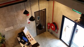A room with a desk, computer, and a fire extinguisher mounted on the wall. - Go Hotel (Subang Jaya)
