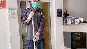 A person mopping the floor in a hotel lobby. - Djo Front One Inn Bengkulu (Bengkulu)