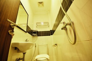 A bathroom with a sink, toilet, and shower.