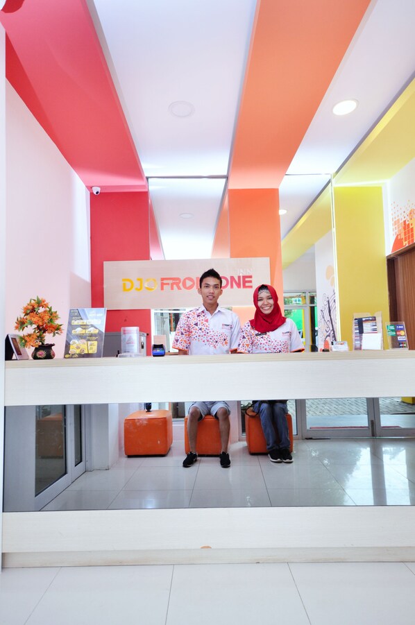A reception desk with a sign that reads "DJO FROM ONE".