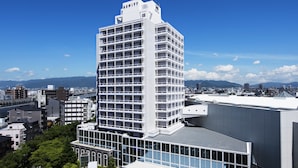 A modern multi-story building with a prominent white facade and a flat roof. - Hotel Hewitt Koshien (Nishinomiya)