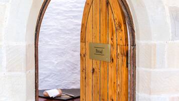 A wooden door with a sign that reads "Bread."