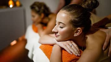 A spa setting with a person receiving a massage.