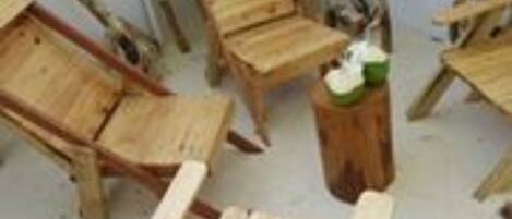 A room with several wooden chairs and a small table.