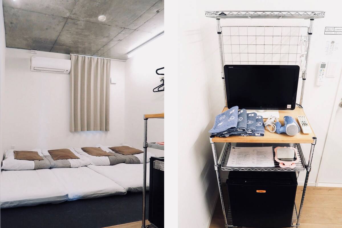 A single bed with a headboard, a bedside table with a lamp, and a window with curtains.